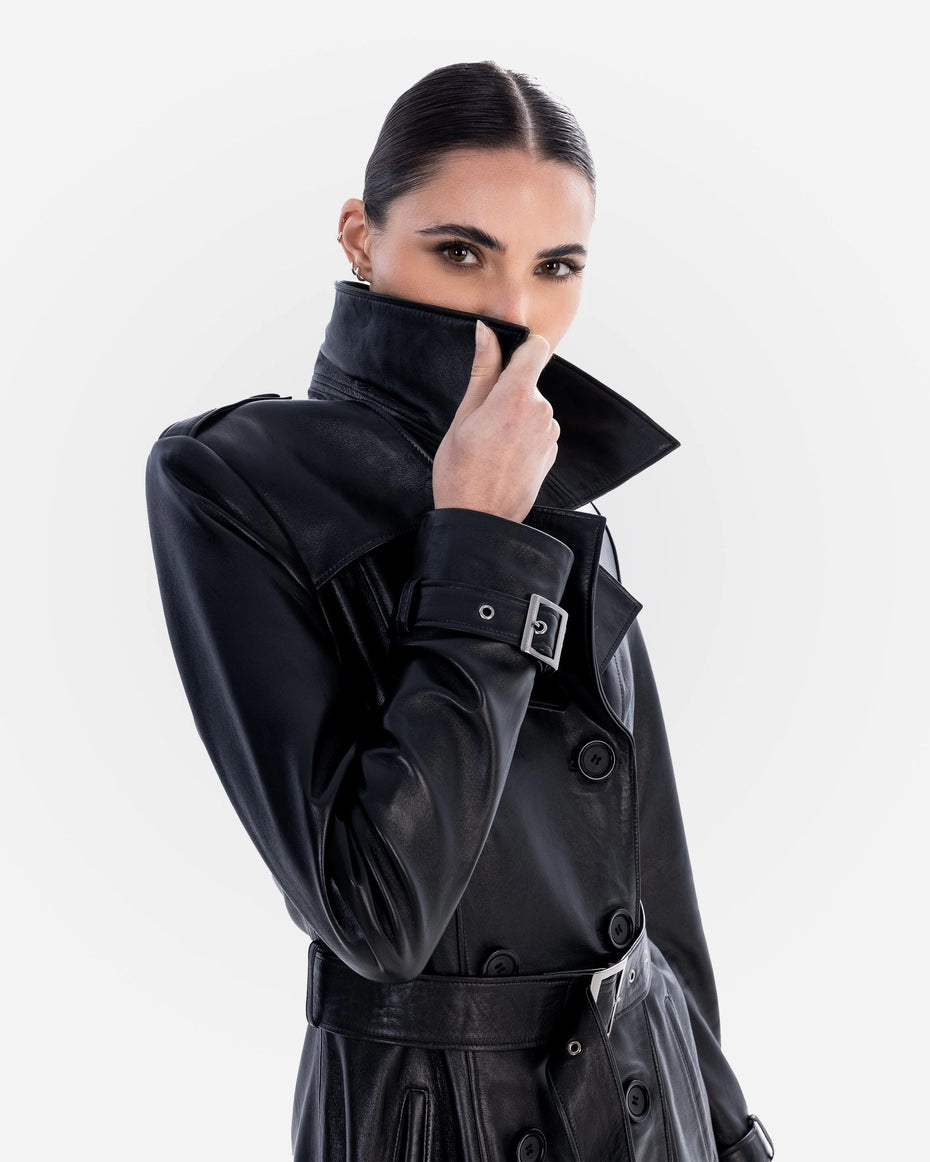 Woman wearing a black trench coat on a white background Cuir Dimitri