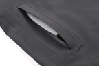 Close-up of a gray fabric pocket with a white object inside on a white background Aparso