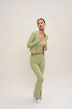Woman wearing a green outfit on a white background