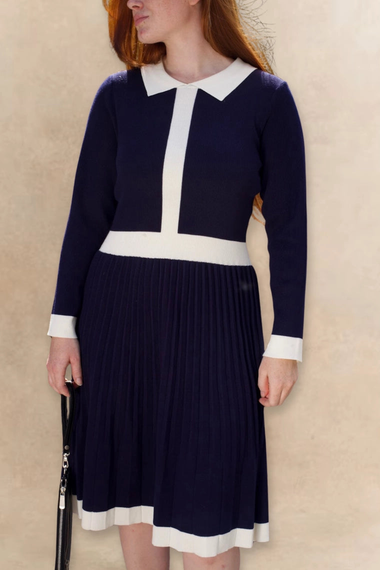 Woman wearing Clarissa knit dress in navy outdoors, lifestyle shot
