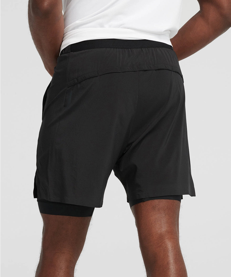 Man wearing black athletic shorts on a light gray background RYU