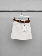 Ecru denim mini skirt with brown leather belt on hanger product view - ANAZ Denim Mini Skirt with Belt