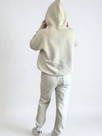 Women wearing a beige hoodie and pants set on a white background PRIV