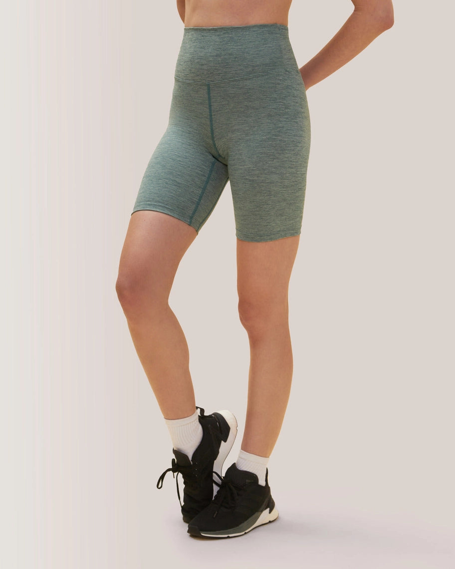 Women wearing teal athletic shorts on a plain background Rose Boreal