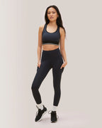 Woman wearing a black athletic outfit on a light gray background Rose Boreal