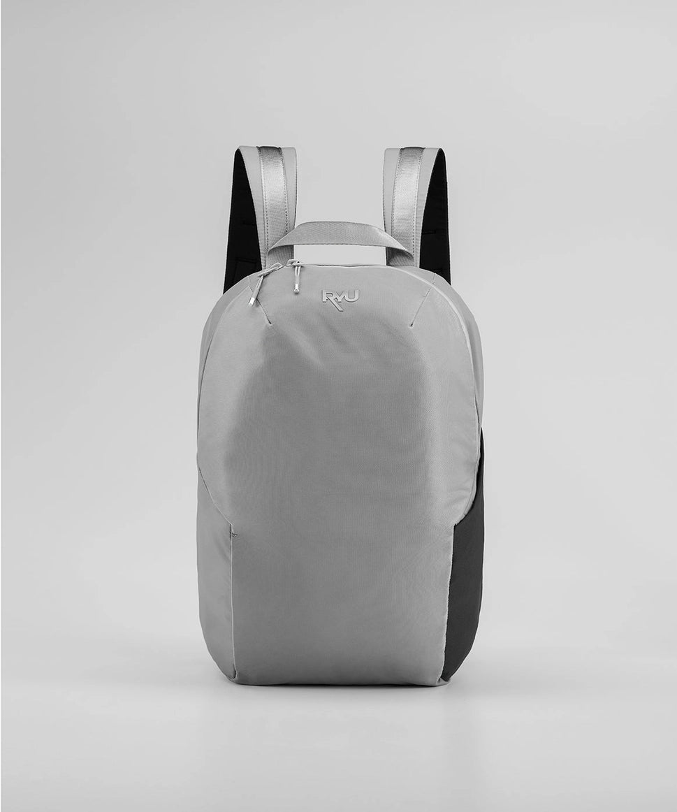 Gray backpack with black accents on a light gray background RYU