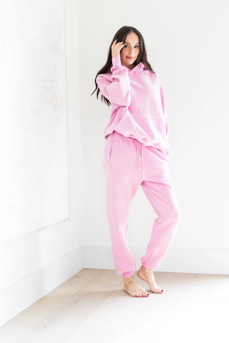 Woman wearing pink pajamas against a white background PRIV