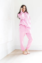 Woman wearing pink pajamas against a white background PRIV