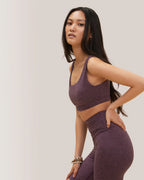 Woman wearing a purple athletic outfit on a plain background Rose Boreal 