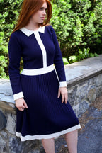 Woman wearing Clarissa knit dress in navy outdoors, lifestyle shot
