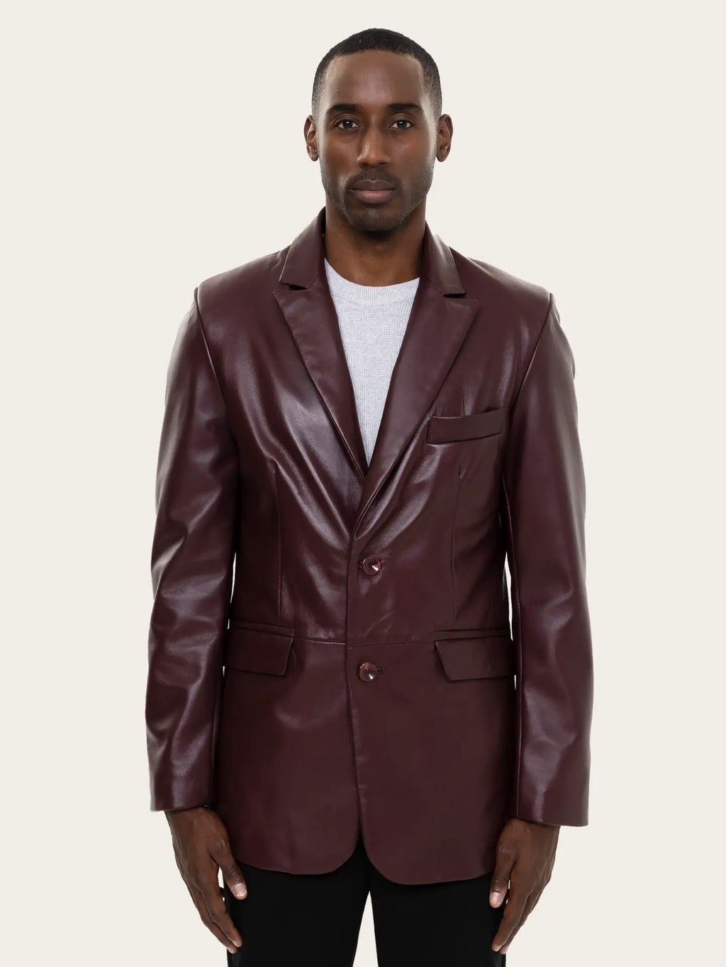 Man wearing a maroon leather blazer on a beige background Cuir Dimitri