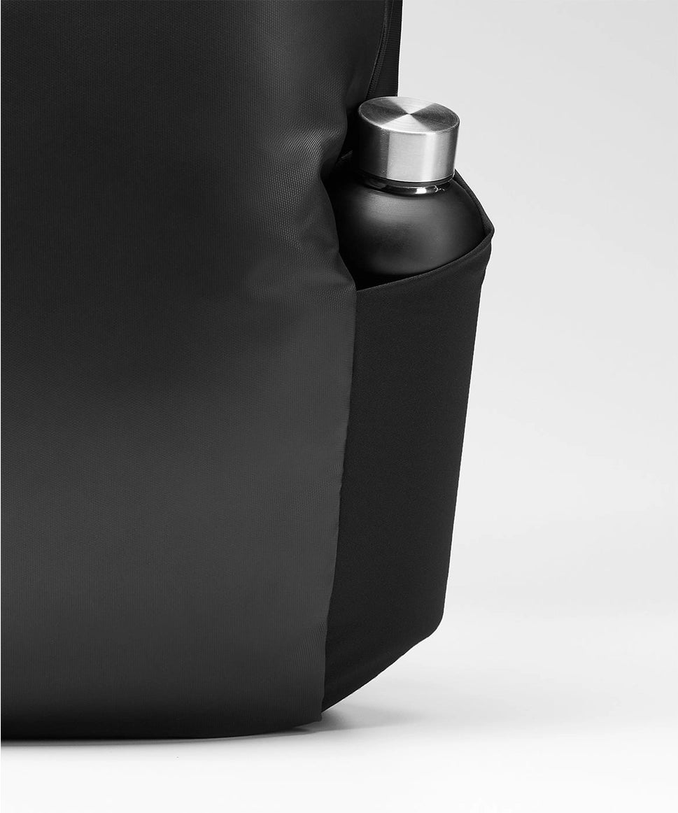 Black water bottle with silver cap inside a black bag on a white background RYU