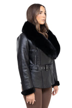 Black leather jacket with fur collar worn by a model on a white background Cuir Dimitri 