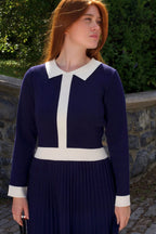 Front view of woman wearing Clarissa knit dress in navy with white contrast collar
