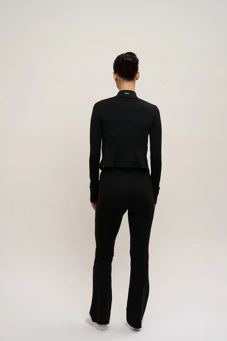 Person wearing a black outfit on a white background