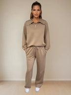 Woman wearing a beige tracksuit against a plain background PRIV