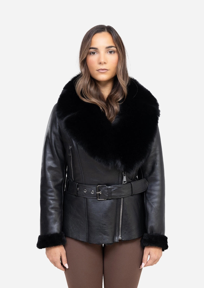 Woman wearing a black leather coat with fur trim on a white background Cuir Dimitri 