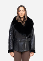 Woman wearing a black leather coat with fur trim on a white background Cuir Dimitri 