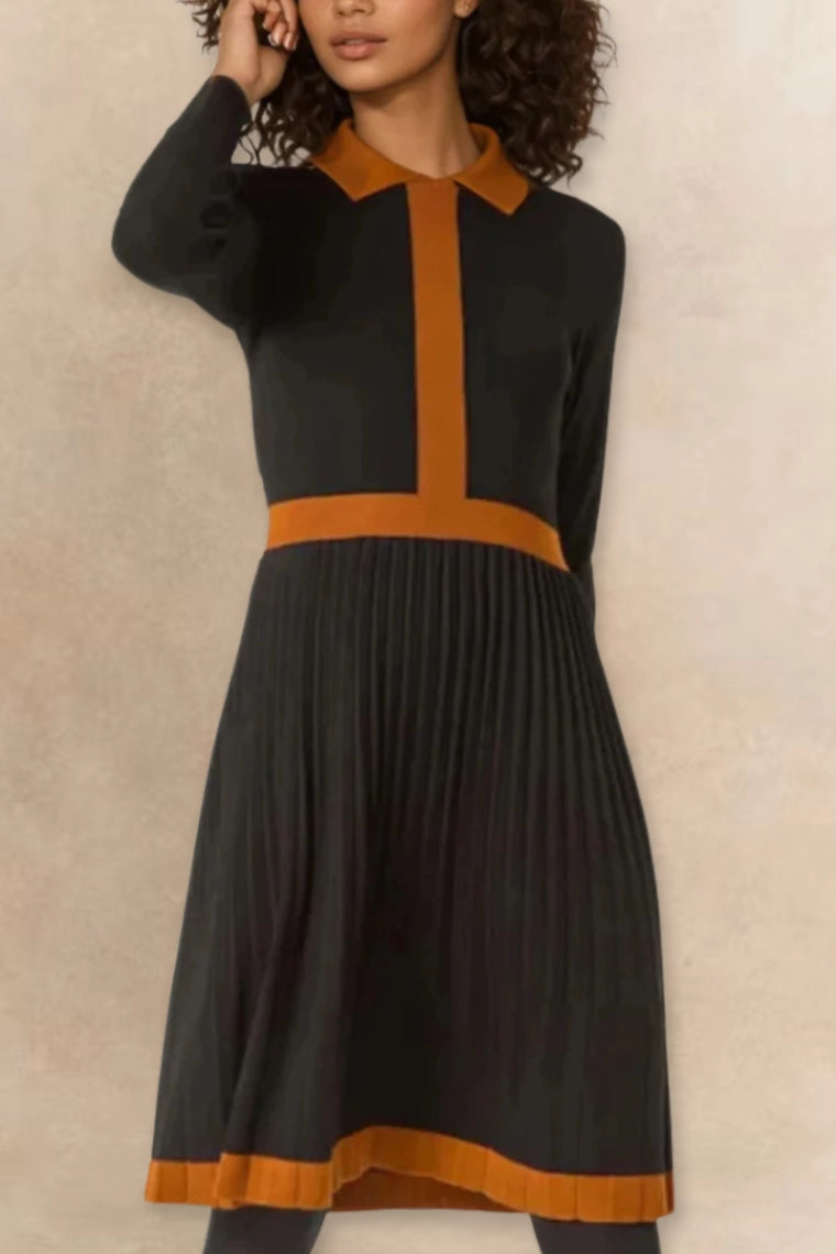 Woman wearing Clarissa knit dress in black with rust orange contrast trim, full length view

