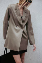 Person wearing a beige blazer against a plain background  Amanda Maria