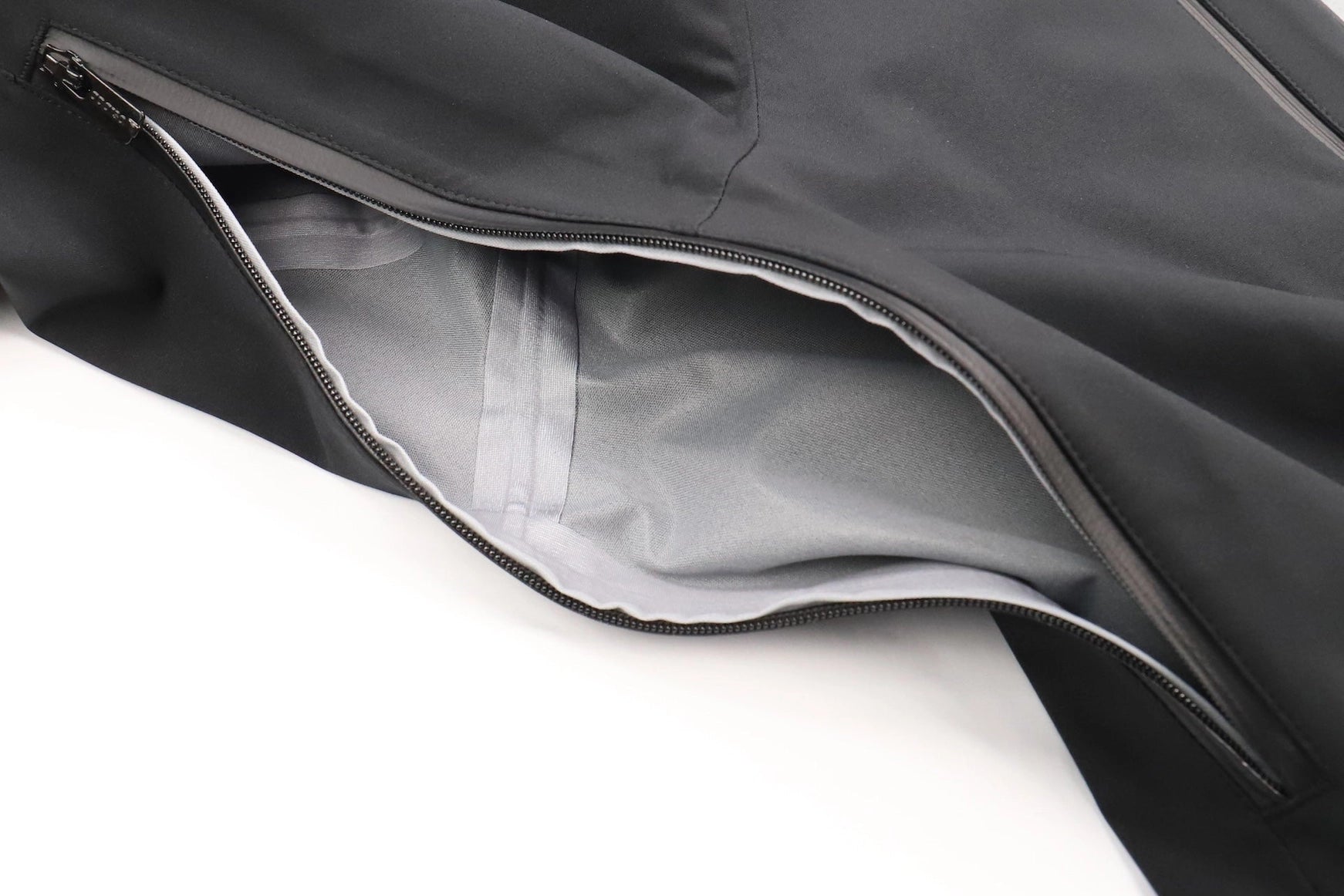 Close-up of a gray jacket with a zipper on a white background Aparso