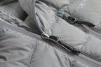 Close-up of a gray puffer jacket with a zipper Aparso
