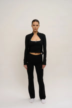 Person wearing a black outfit with a white background