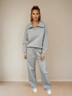 Woman wearing a gray tracksuit against a beige background PRIV
