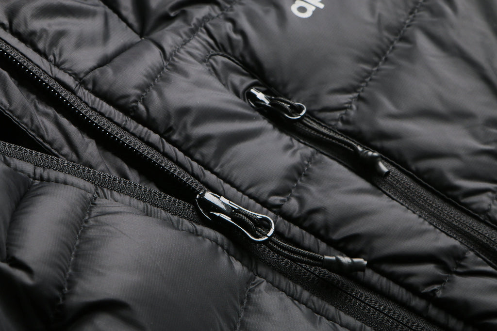 Close-up of a black puffer jacket with a zipper Aparso