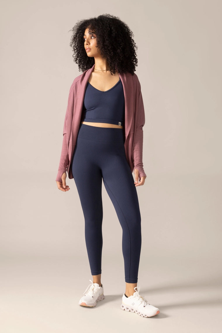 Woman wearing a blue rose boreal outfit against a beige background