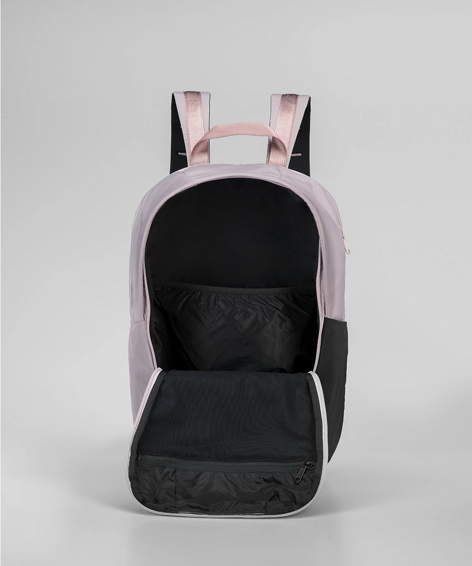 Backpack with black interior and pink exterior on a light gray background RYU