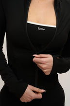 Person wearing a black outfit with 'bov' branding on a plain background