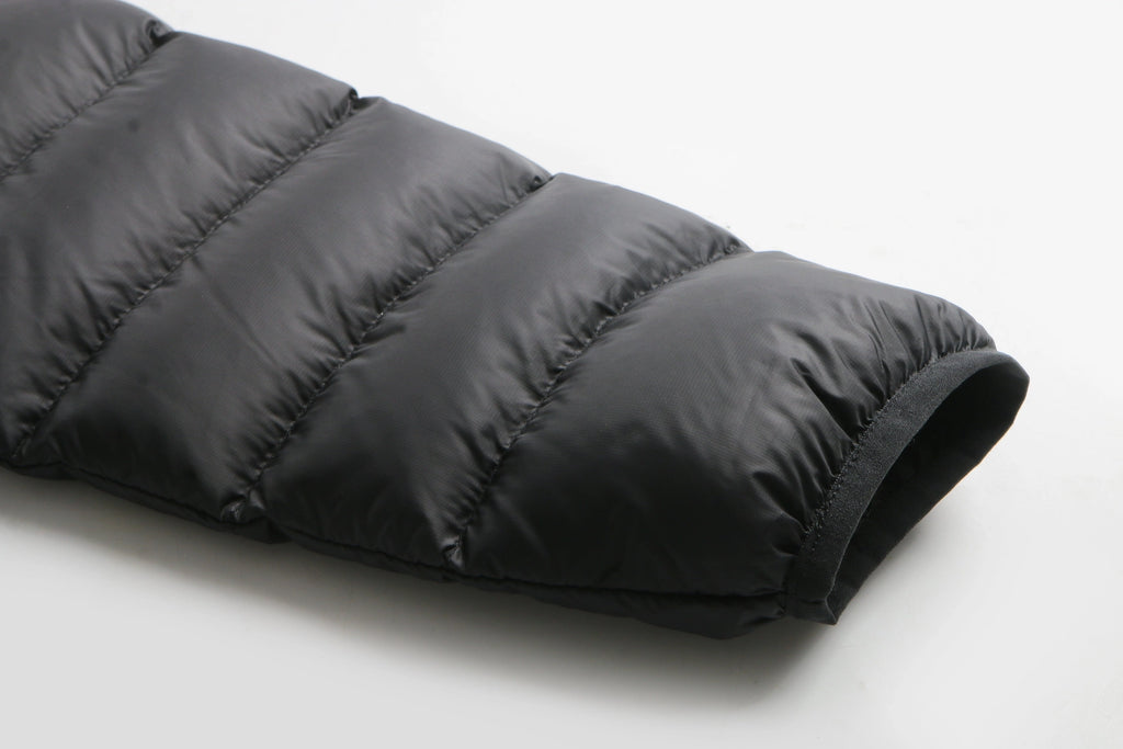 Black puffer jacket on a light gray background Aparso