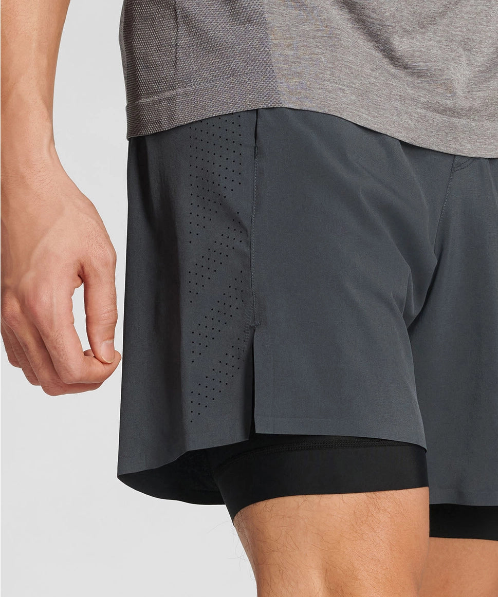 Gray athletic shorts with a black waistband on a light gray background RYU