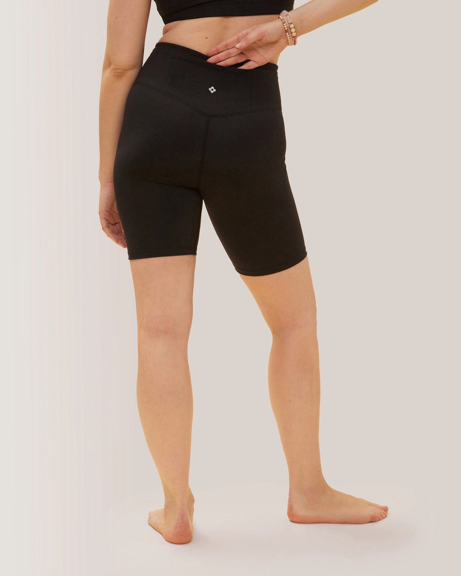Women wearing black athletic shorts on a plain background Rose Boreal