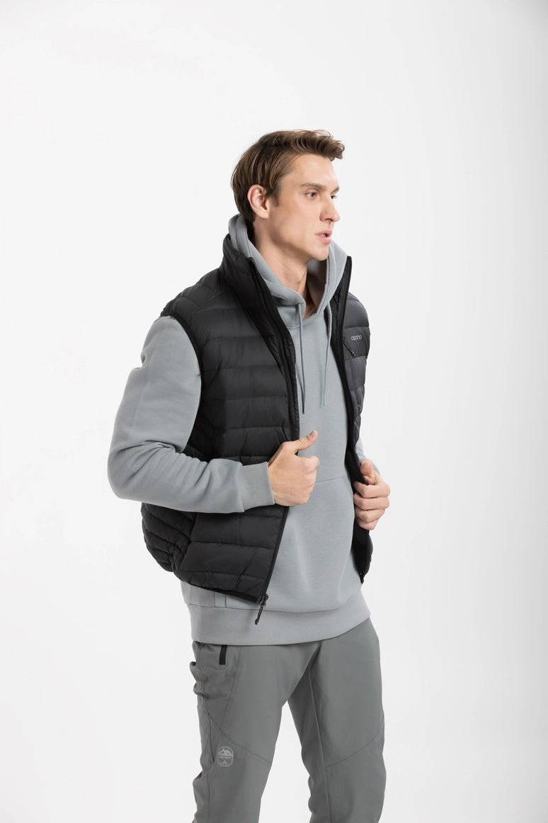 Man wearing a gray hoodie, black puffer vest, and gray pants on a white background Aparso