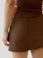 Brown skirt worn by a women on a light background