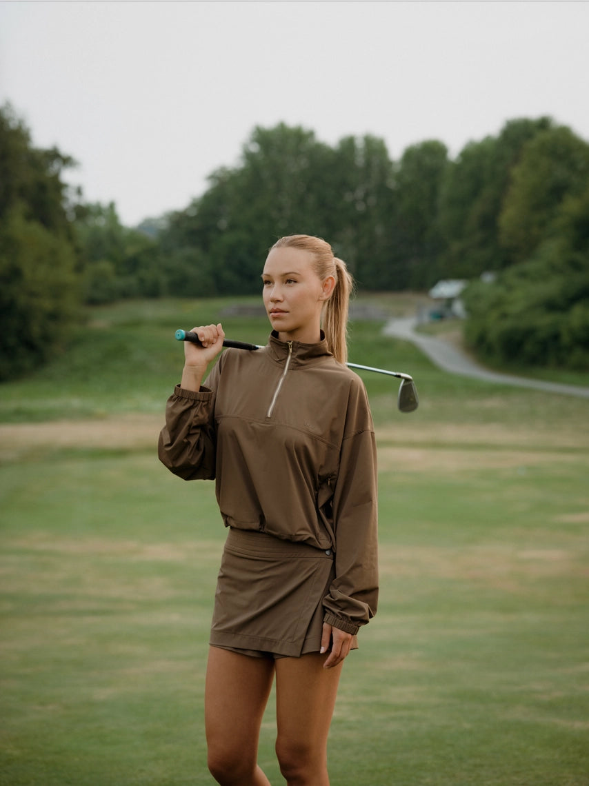 Woman holding a golf club on a golf course