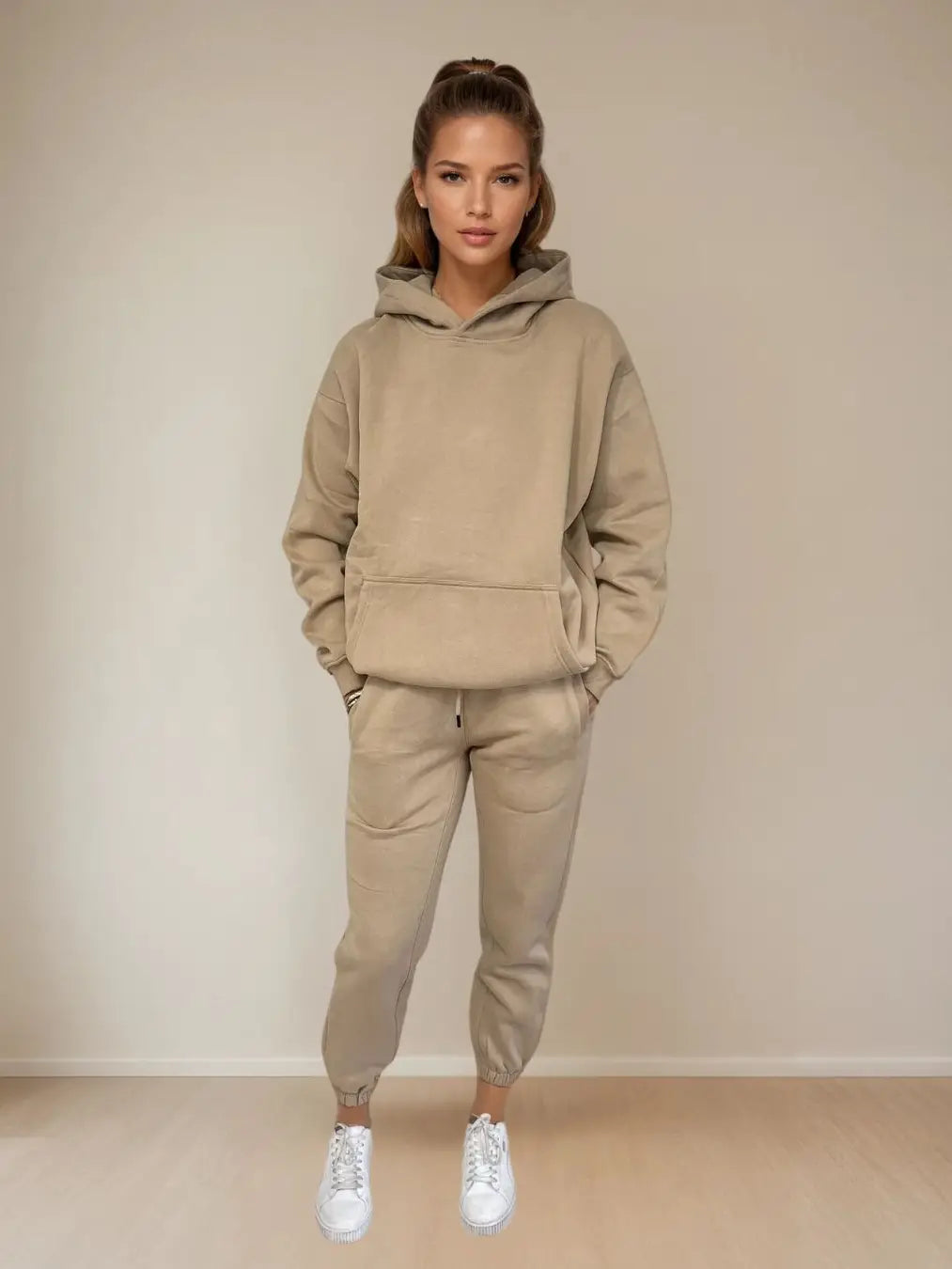 Women wearing a beige hoodie and pants set against a plain background PRIV