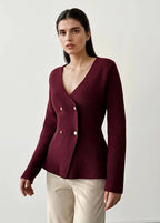 Woman wearing a burgundy cardigan with gold buttons on a white background ANAZ