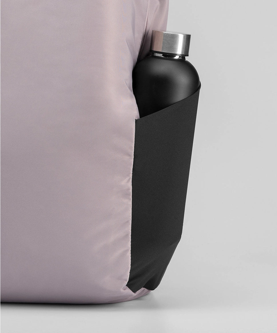 Black water bottle with silver cap inside a black sleeve against a light gray background RYU