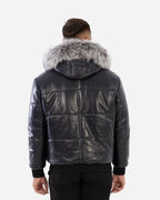 Man wearing a black leather jacket with fur hood on a white background Cuir Dimitri