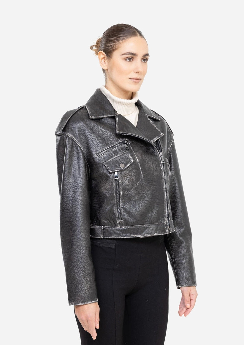 Woman wearing a black leather jacket on a white background Cuir Dimitri