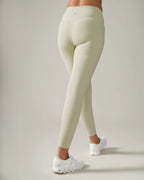 Women wearing light green leggings on a plain background Rose Boreal