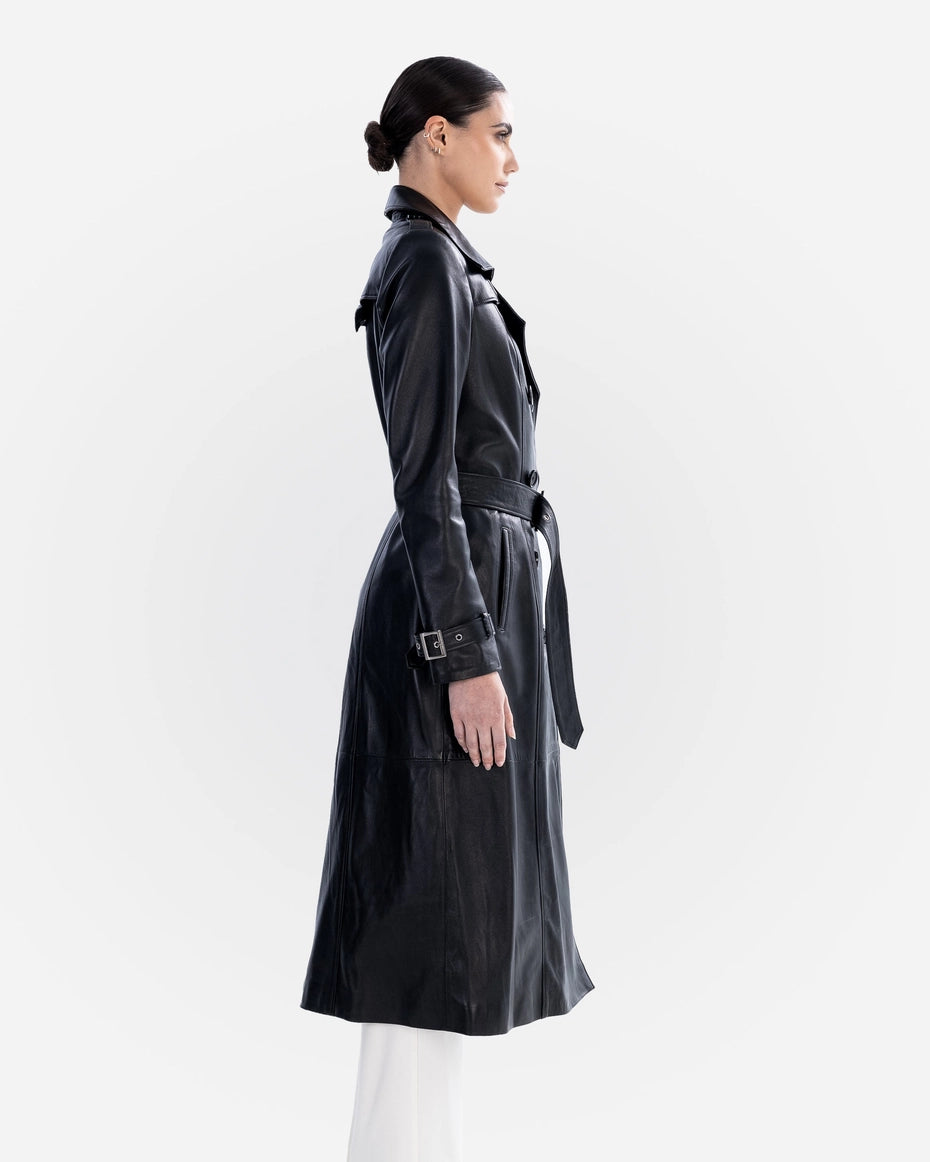 Woman wearing a black trench coat on a white background Cuir Dimitri