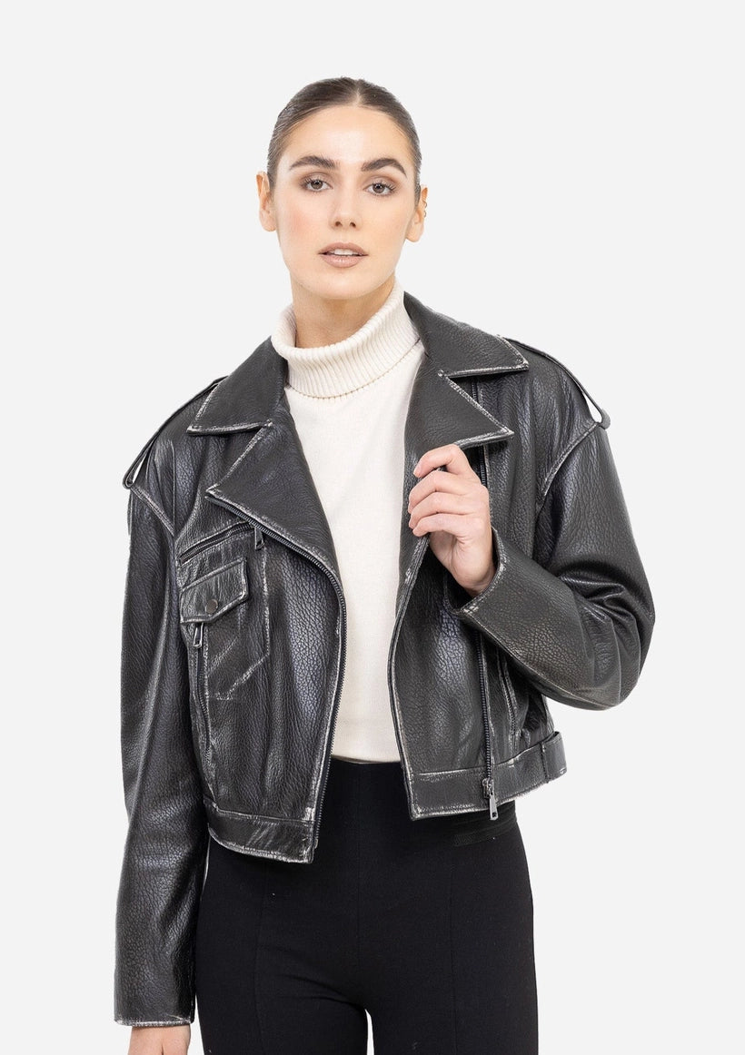 Woman wearing a black leather jacket over a white sweater on a white background Cuir Dimitri