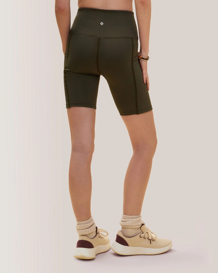 Women wearing olive green athletic shorts on a plain background Rose Boreal