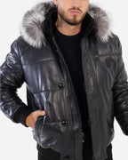 Man wearing a black leather jacket with fur hood on a white background Cuir Dimitri