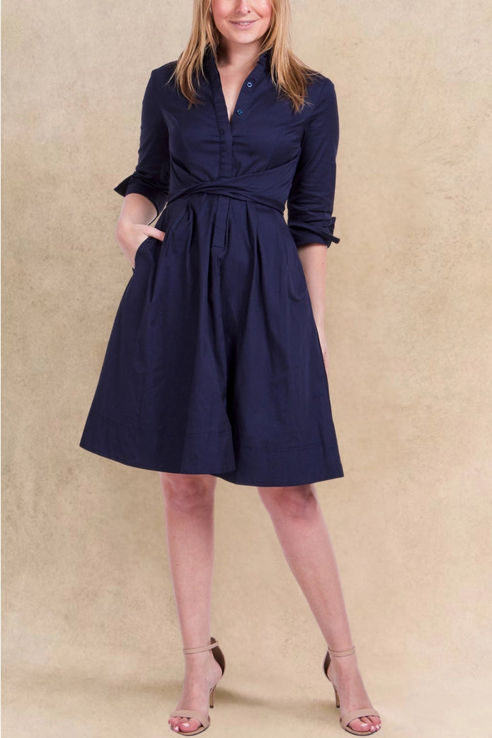 Woman wearing a navy blue dress with a beige background ANNICK