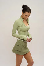 Woman wearing a green dress with a white background